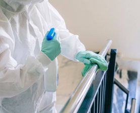 A,Person,Wearing,A,Mask,,Gloves,And,A,Safety,Suit